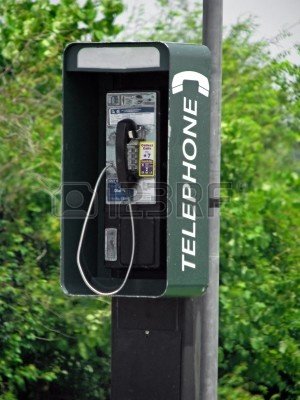 3313813-an-outside-telephone-pay-phone-on-pole.jpg