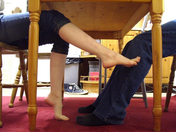 footsy_under_the_table_by_artistic_feet.