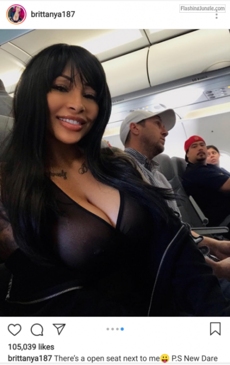 Deep cleavage pale black bimbo in airplane boobs flash